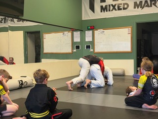 Young Crosse Training students watching a jiu-jitsu demonstration
