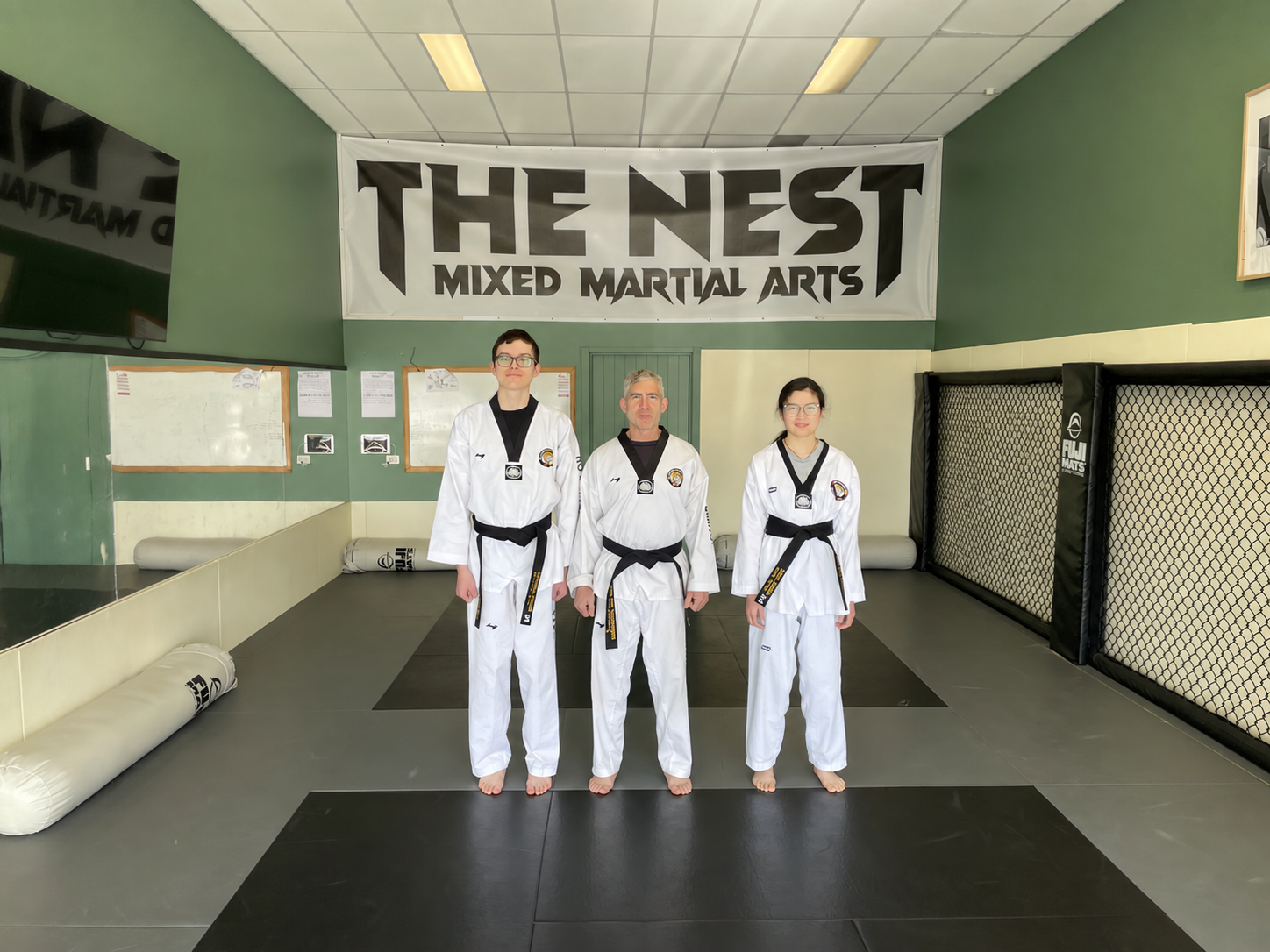 Michael, Tyrone and Lilly wearing their Taekwondo black belts at The Nest