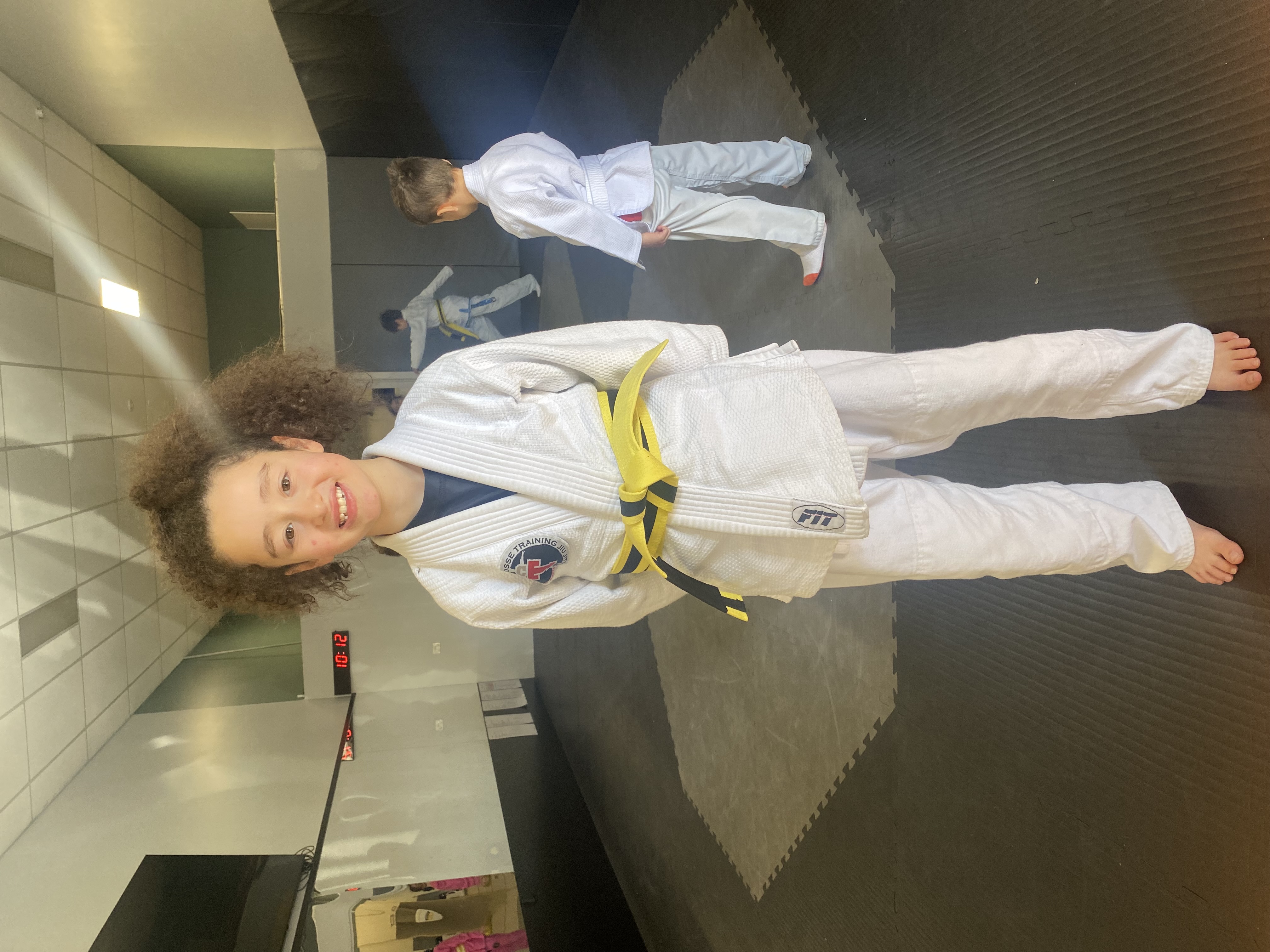 Young Crosse Training student in a white jiu-jitsu uniform and yellow belt